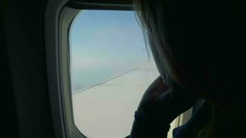 Woman looking out the window in airplane video