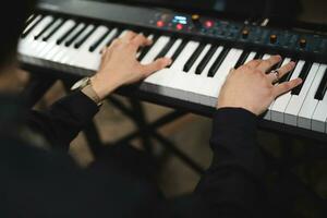 close-up of a pianist's hands while playing the piano photo