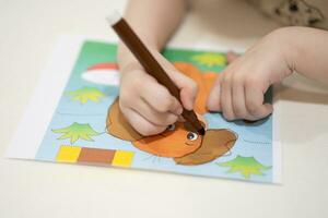 a small child is learning to draw a picture photo