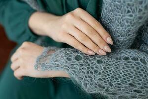 close-up of a warm woolen scarf woman shows on her hand photo