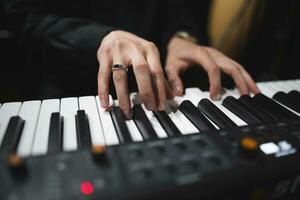 close-up of a pianist's hands while playing the piano photo