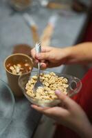 the confectioner sprinkles nuts on the dessert photo