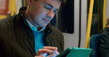 Male passenger with touch pad in subway train video