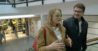 Man and woman walking upstairs in trade centre video