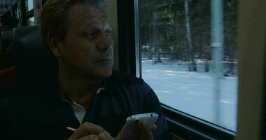 Senior man texting on cell phone in train video