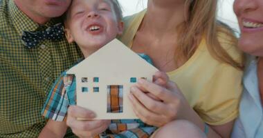 Real estate concept with happy family and small wooden house video