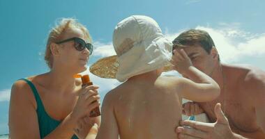 Family having fun applying sunscreen video