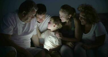Big family and child with pad outdoor at night video
