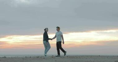 Young people in headphones exercising on the beach video