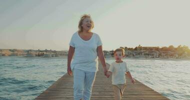 Grandmother and grandson having outdoor walk on resort video