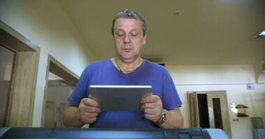 Man with touch pad exercising on treadmill video