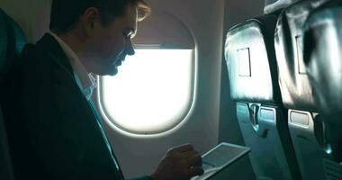 Man using tablet computer during the flight video