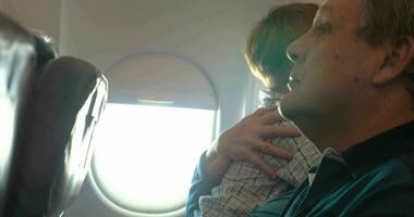 ragazzo e il suo nonna abbracciare nel il aereo video