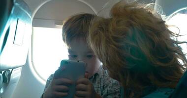 Grandmother and grandson with cell in the plane video