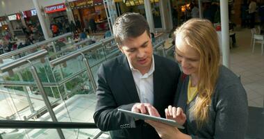 Couple with Tablet PC on Escalator video