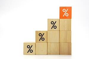 Wooden blocks with percentage sign. Interest rate finance, investment and interest rate increases. photo