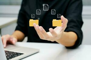 Man working on laptop with holding virtual data transmission icon. Concept of technology and future business. photo