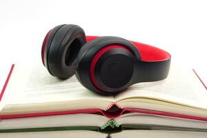 The headphones are on stack of books. Modern education and relaxation concept. photo