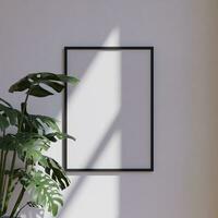 clean minimalist frame mockup poster hanging on the white wall lit by sunlight with plant decoration photo
