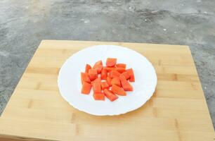 papaya slices on the white plat photo