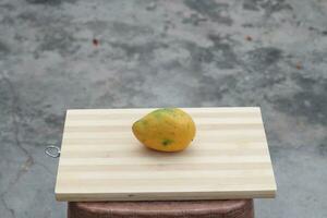 mango fruit on wooden surface photo