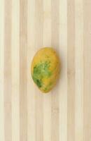 mango fruit on wooden surface photo