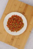 Dal ki Mithori on a White plate and wooden Background, top view photo