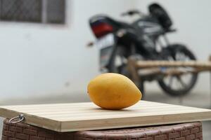 mango fruit on wooden surface photo