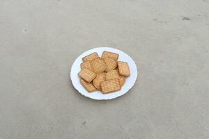 galletas en un blanco plato en el piso. foto