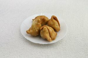 A samosa is a fried South Asian dish photo