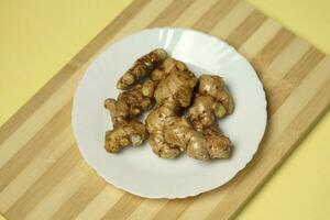 Ginger root in the plat photo