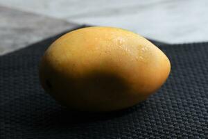 mango fruit on wooden surface photo