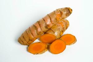 Turmeric rhizome kunyit on the white background photo