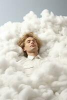 Surreal artist laying on a fluffy cloud isolated on a white background photo