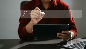 Searching Browsing Internet Data Information Networking Concept with blank search bar.man working with mobile phone and laptop computer VR icon photo