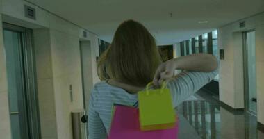 Woman with shopping bags in hotel hall video