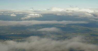 Aerial view to city through the clouds video