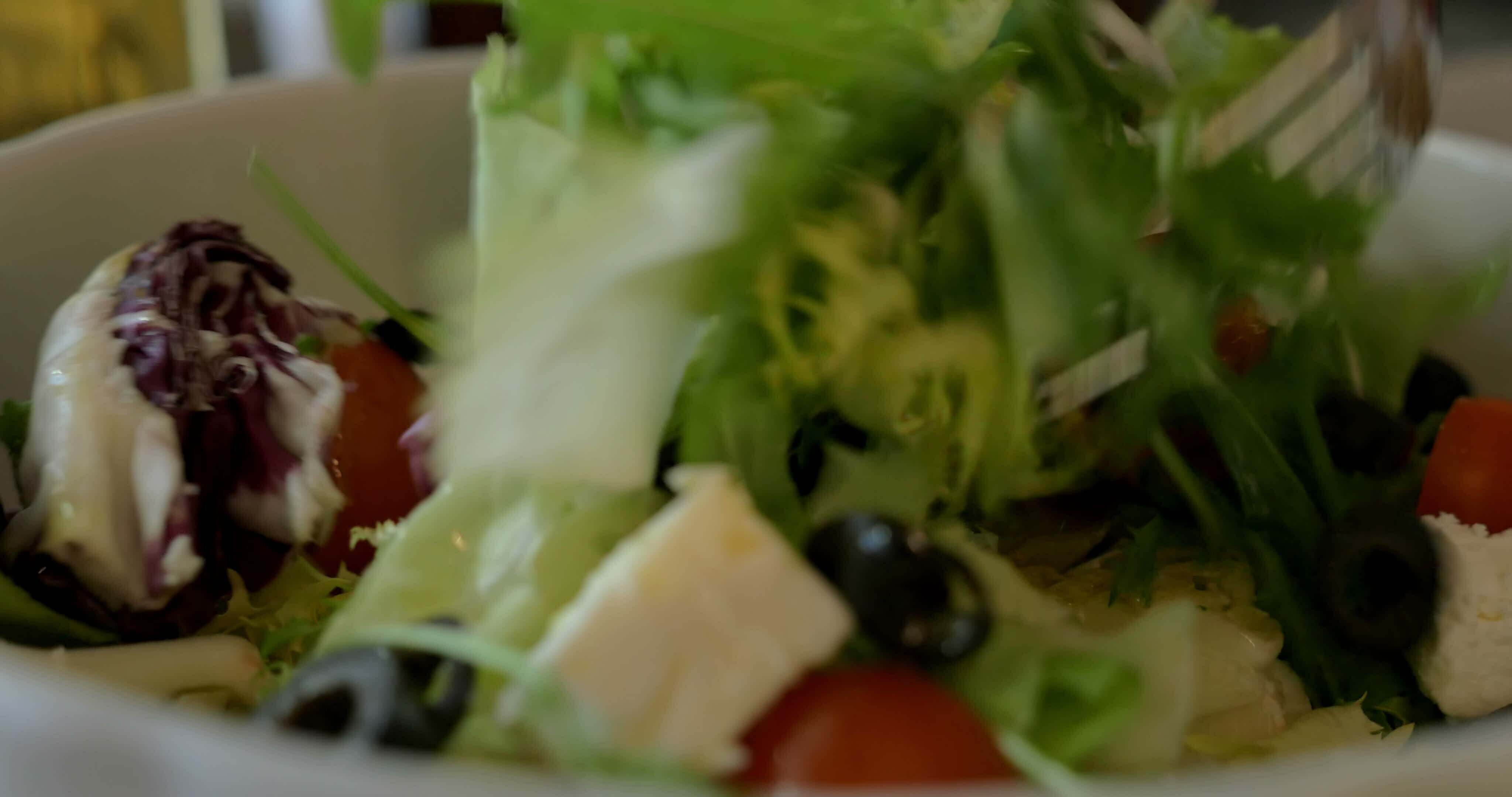 Tossing Greek salad before eating 29199856 Stock Video at Vecteezy