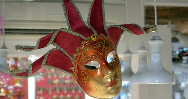 Red Venetian mask hanging in the store video