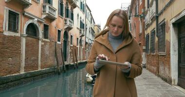 Woman wandering in Venice with pad video