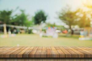 Empty wooden table top and Abstract blurred light bokeh and blur background of garden trees in sunlight. product display template with copy space. photo