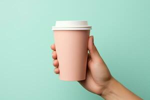 hand holding coffee paper cup on pastel background.Generative ai. photo