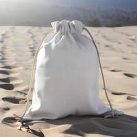 a white bag sitting on the sand near a river. . photo