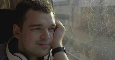 Man traveling by train and enjoying outside view video