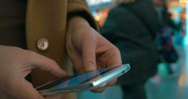 Woman hands typing on mobile at the station video