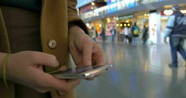 Female hands using cell phone at the station video