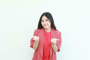 portrait of beautiful asian woman wearing red outfit with hand gesture presenting something or copy space photo