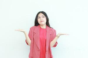 portrait of beautiful asian woman wearing red outfit with confused gesture photo