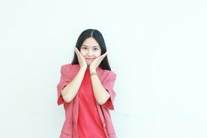 portrait of beautiful asian woman wearing red outfit with smiling gesture photo