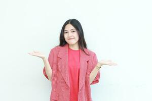 portrait of beautiful asian woman wearing red outfit with confused gesture photo